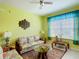 Bright living room with tropical decor, comfortable seating, and natural light from a large window at 2781 Almaton Loop # 404, Kissimmee, FL 34747