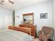 Spacious primary bedroom featuring wooden furniture, a ceiling fan and calming light-blue walls at 2781 Almaton Loop # 404, Kissimmee, FL 34747
