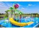 Vibrant community splash pad with slide and water features, perfect for Gathering fun on a bright, sunny day at 2781 Almaton Loop # 404, Kissimmee, FL 34747
