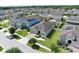 An aerial view showcases the home's manicured lawn and landscaping in a residential neighborhood at 299 Whirlaway Dr, Davenport, FL 33837