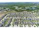 An aerial view showcasing a neighborhood with green spaces, homes, and access to community amenities at 299 Whirlaway Dr, Davenport, FL 33837