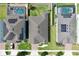 An aerial view of backyards with pools, play equipment, and green lawns, surrounded by fences at 299 Whirlaway Dr, Davenport, FL 33837