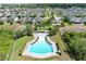 Community pool with sun loungers and verdant landscaping, surrounded by well-maintained homes in an idyllic neighborhood at 299 Whirlaway Dr, Davenport, FL 33837