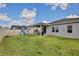 Spacious backyard featuring a covered patio, playset, and lush green lawn perfect for outdoor fun at 299 Whirlaway Dr, Davenport, FL 33837