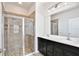 Bathroom featuring double sink vanity, tiled shower, and glass door at 299 Whirlaway Dr, Davenport, FL 33837