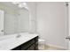 Bright bathroom features a single sink vanity and tiled shower at 299 Whirlaway Dr, Davenport, FL 33837