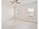 Bright bedroom with neutral carpet, a ceiling fan, and two large windows at 299 Whirlaway Dr, Davenport, FL 33837
