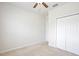 This cozy bedroom features a ceiling fan and a spacious closet at 299 Whirlaway Dr, Davenport, FL 33837