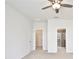 Bright bedroom featuring a ceiling fan, closet and bathroom access at 299 Whirlaway Dr, Davenport, FL 33837