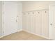 Bright foyer featuring a white door, neutral walls with hook accents, and durable tile flooring at 299 Whirlaway Dr, Davenport, FL 33837