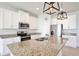 Modern kitchen with white cabinets, stainless steel appliances, and granite countertops at 299 Whirlaway Dr, Davenport, FL 33837