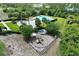 Aerial view of community playground, manicured grounds, outdoor lounge, pool and lush surrounding landscapes at 299 Whirlaway Dr, Davenport, FL 33837