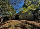 The backyard offers mature trees and privacy in a naturally landscaped setting at 3144 Ginger Cir, Orlando, FL 32826