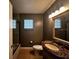 Bathroom with decorative lights, vanity, glass block window and a tub with shower at 3144 Ginger Cir, Orlando, FL 32826
