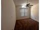 This bedroom features a ceiling fan, natural lighting, and neutral-toned carpet at 3144 Ginger Cir, Orlando, FL 32826
