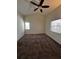 Carpeted bedroom with two large windows and a ceiling fan at 3144 Ginger Cir, Orlando, FL 32826