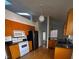 Bright kitchen featuring wooden cabinets, stainless steel appliances, and a skylight for natural lighting at 3144 Ginger Cir, Orlando, FL 32826