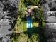 Aerial perspective of home showcasing a pool, manicured grounds and verdant surroundings at 320 Mary Jess Rd, Orlando, FL 32839