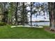 Spacious backyard with Adirondack chairs, fire pit, picnic table, and lake access, ideal for entertaining at 320 Mary Jess Rd, Orlando, FL 32839
