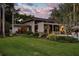Lush backyard with a covered patio and landscaped garden providing a serene outdoor living space at 320 Mary Jess Rd, Orlando, FL 32839