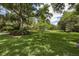 Lush green lawn with mature trees, offering a serene and expansive outdoor space at 320 Mary Jess Rd, Orlando, FL 32839