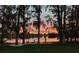 Beautiful lakefront backyard with inviting lounge chairs and a stunning sunset view at 320 Mary Jess Rd, Orlando, FL 32839