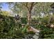 Backyard featuring beautiful landscaping and mature trees offering shade and privacy at 320 Mary Jess Rd, Orlando, FL 32839