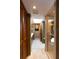Hallway between the main bedroom and main bathroom with a glass shower stall and bright, neutral finishes at 320 Mary Jess Rd, Orlando, FL 32839