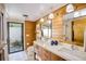 Modern bathroom featuring double sink vanity with wood paneling and natural stone at 320 Mary Jess Rd, Orlando, FL 32839