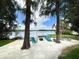 Relaxing beach area with Adirondack chairs, a fire pit, and a lake view, perfect for outdoor gatherings at 320 Mary Jess Rd, Orlando, FL 32839