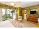 Bedroom featuring backyard views, a ceiling fan, and a seating area at 320 Mary Jess Rd, Orlando, FL 32839