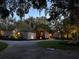 Stunning home exterior at twilight, featuring unique stone accents and professional landscape lighting at 320 Mary Jess Rd, Orlando, FL 32839