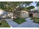 Unique home exterior showcasing stone accents and a well-manicured front yard with mature trees at 320 Mary Jess Rd, Orlando, FL 32839