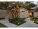 Unique home exterior showcasing stone accents and a well-manicured front yard with mature trees at 320 Mary Jess Rd, Orlando, FL 32839