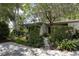 Exterior featuring lush landscaping and privacy hedges at 320 Mary Jess Rd, Orlando, FL 32839