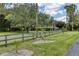 Well-manicured lawn and attractive grey wooden fence create a welcoming exterior landscape at 320 Mary Jess Rd, Orlando, FL 32839