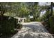 Garage and long driveway shaded by mature trees, adding to the property's charm at 320 Mary Jess Rd, Orlando, FL 32839