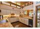 Efficient kitchen with upper clerestory windows, warm toned cabinets, brick backsplash and unique decor at 320 Mary Jess Rd, Orlando, FL 32839