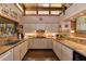Functional kitchen with brick backsplash, lighter colored cabinets, and an adjacent pass-through to dining area at 320 Mary Jess Rd, Orlando, FL 32839
