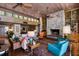 Living room with brick floors, a stone fireplace, and walls of glass overlooking outdoor dining at 320 Mary Jess Rd, Orlando, FL 32839