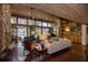Living room featuring brick floors, a stone fireplace, and floor-to-ceiling windows with pool views at 320 Mary Jess Rd, Orlando, FL 32839