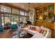 Living room featuring brick floors, built-in shelving, and walls of glass overlooking the pool at 320 Mary Jess Rd, Orlando, FL 32839