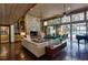 Spacious living room with brick floors, a stone fireplace, and walls of glass overlooking the pool at 320 Mary Jess Rd, Orlando, FL 32839