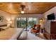 Bright main bedroom offering backyard garden views, warm lighting, and a seating area at 320 Mary Jess Rd, Orlando, FL 32839