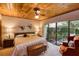 Relaxing bedroom with wood ceiling, natural light and backyard view at 320 Mary Jess Rd, Orlando, FL 32839