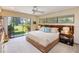 The primary bedroom features an extra large window with lush views and warm lighting at 320 Mary Jess Rd, Orlando, FL 32839