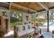 Inviting covered patio with comfortable seating, decorative elements, and lush garden views at 320 Mary Jess Rd, Orlando, FL 32839
