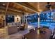 Charming patio area with pool and lake views, comfortable lounge area and wooden dining table at 320 Mary Jess Rd, Orlando, FL 32839