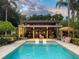 Beautiful backyard pool area with lounge chairs and stylish outdoor seating for relaxation and entertainment at 320 Mary Jess Rd, Orlando, FL 32839