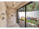 Open shower with high end fixtures and sliding glass doors to private outdoor sanctuary at 320 Mary Jess Rd, Orlando, FL 32839